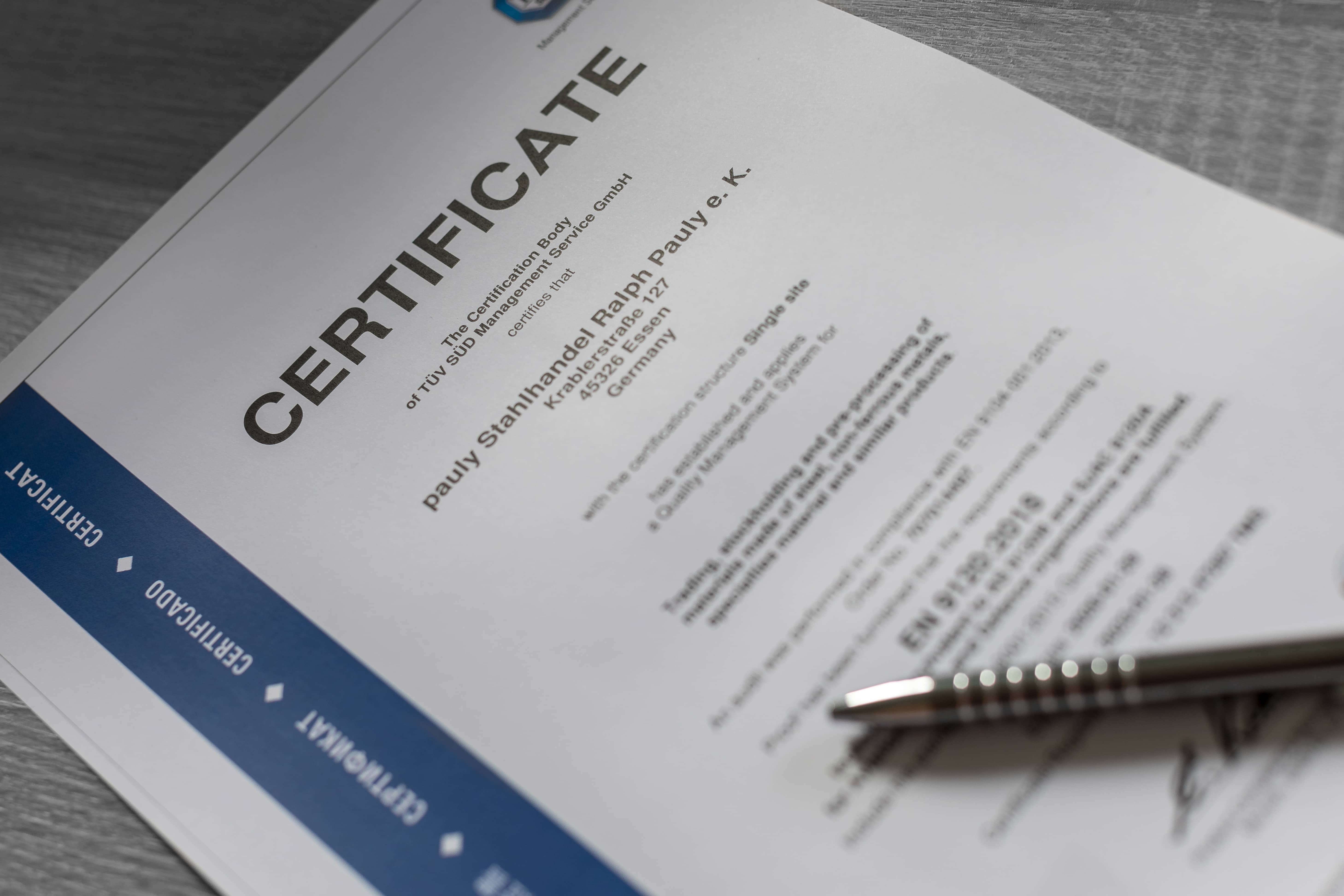 One of our latest steel TÜV certificates with a ballpoint pen